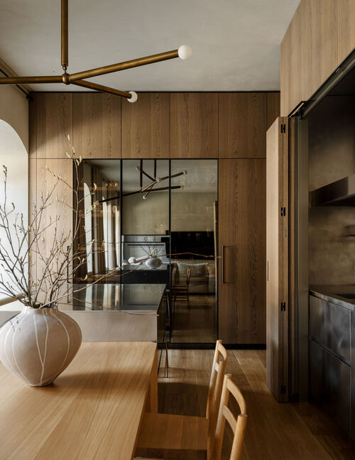 Fossil oak cabinetry with glass modules in a residence featuring an Arclinea kitchen.