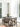 Dining area with wishbone chairs and dark wood table by floor-to-ceiling curtained windows