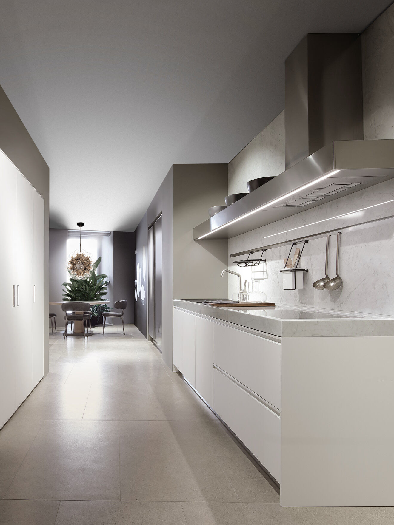 White marble kitchen counter with hood, viewed down a hallway