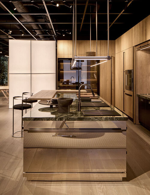 Arclinea Proxima kitchen detail with marble countertop, sink and suspended lighting