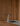 Arclinea kitchen Convivium detail of stainless faucet and stone worktop against wood panels