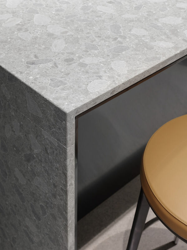 Close up of terrazzo island corner beside a bar stool