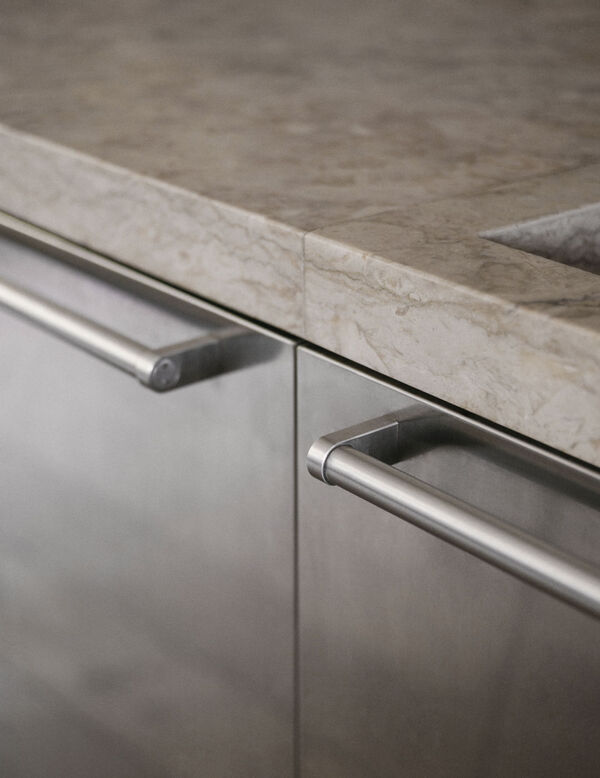 Arclinea Artusi kitchen close-up showing integrated stone sink and steel handles
