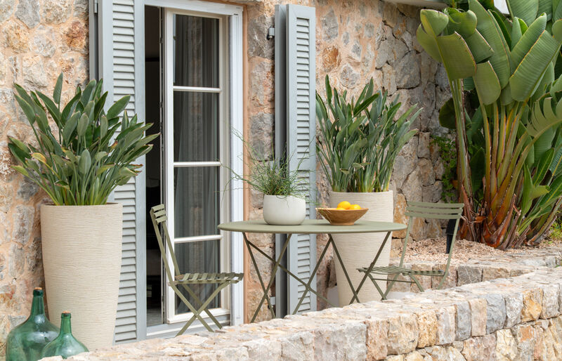 outdoor terrace with stone facade and compact dining set