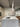 Terrazzo kitchen island with steel sink and pendant light