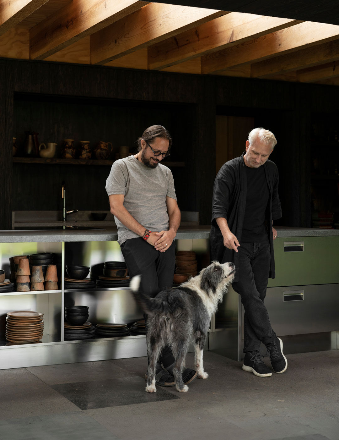 The owner of the Rain harvest home in Mexico, with their dog,, in front of the Arclinea kitchen
