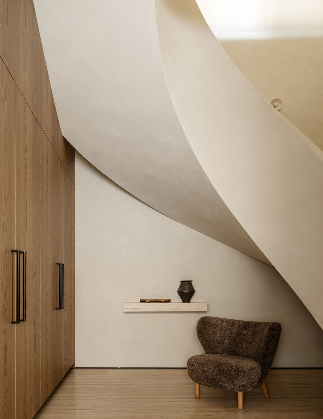 Sculptural curved staircase within a home designed around an Arclinea kitchen.