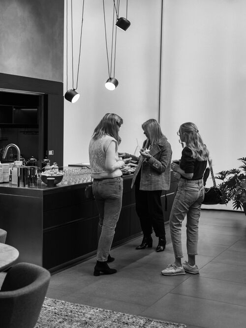Three women talking at Arclinea kitchen counter during London Design Festival event
