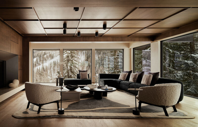 Contemporary living room with built-in fireplace, wood paneling, and neutral furnishings in the Arclinea project