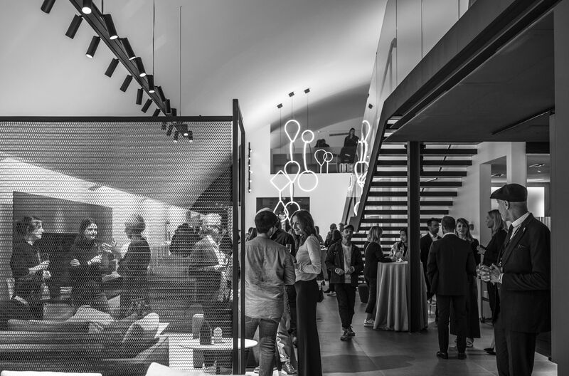 Guests mingling near staircase at Arclinea London Design Festival event