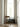 Wooden folding chair beside curtained window and vintage radiator