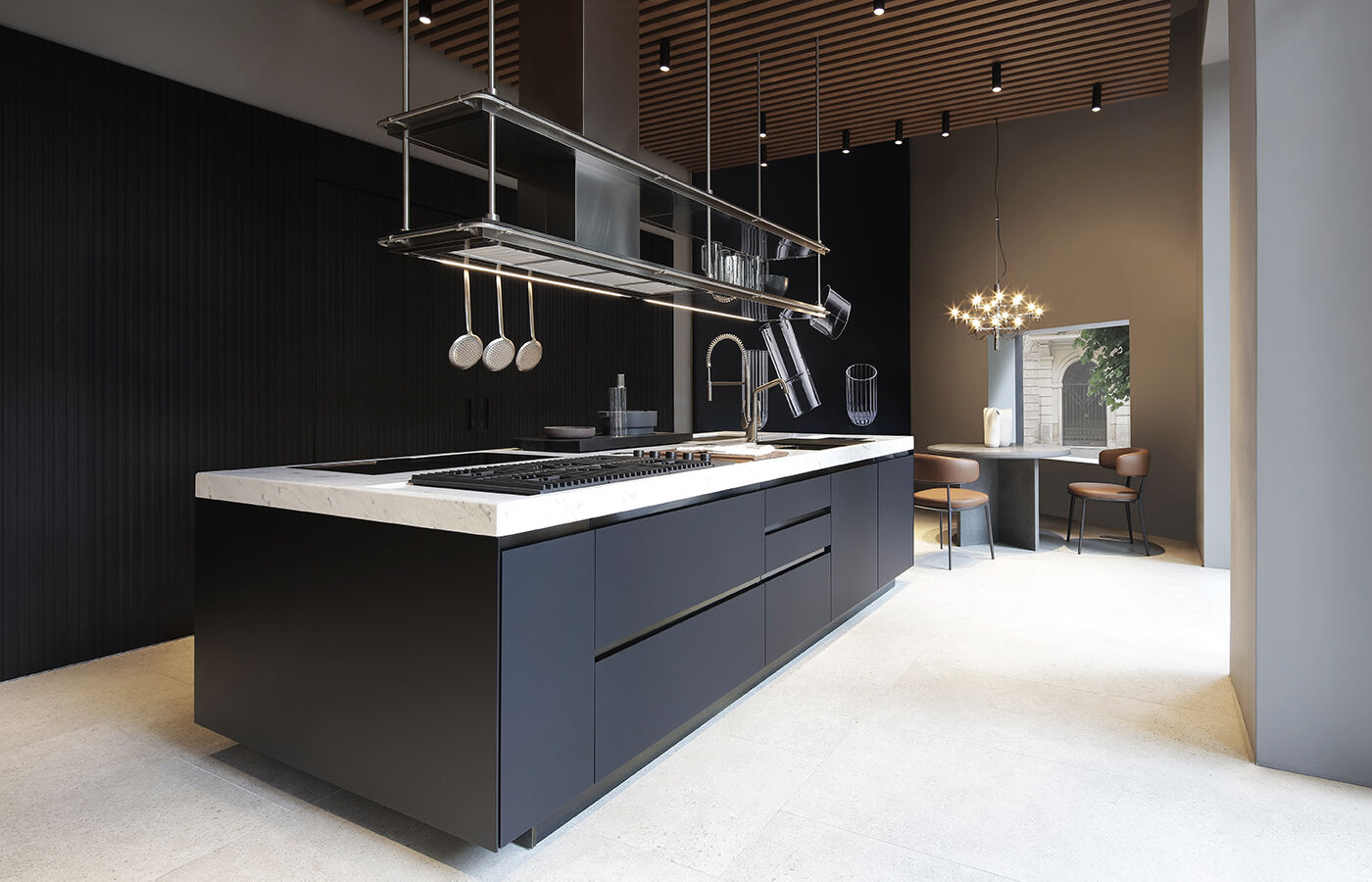 Convivium island in black Fenix NTM®, with Convivium New Professional handle in black PVD and polished Carrara marble worktop. Double Suspended Shelf in stainless steel.
