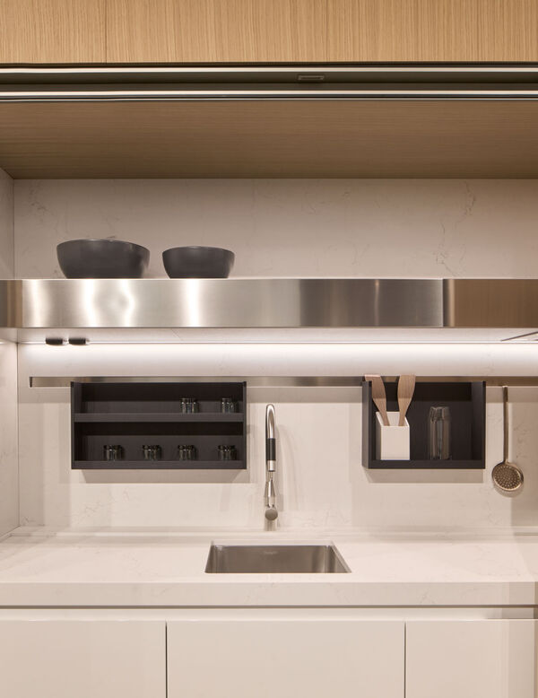 Arclinea Thea kitchen detail with sink, white worktop, open shelves and integrated lighting