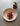 Overhead view of a plated dish with seared meat, mashed potato and pink crumble garnish beside a glass of tea with fresh thyme