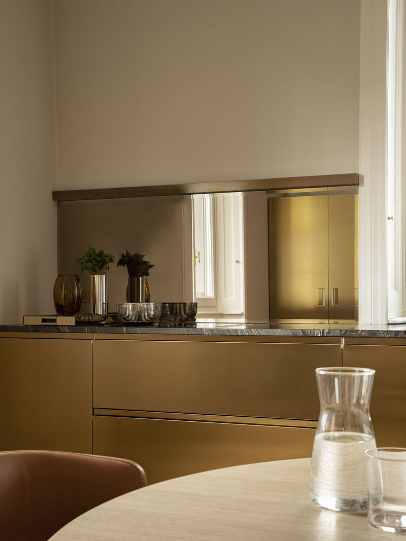 Arclinea modern kitchen with brass detail and marble table