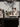Chef pouring sauce over plated dishes at Arclinea kitchen sink station in front of seated guests